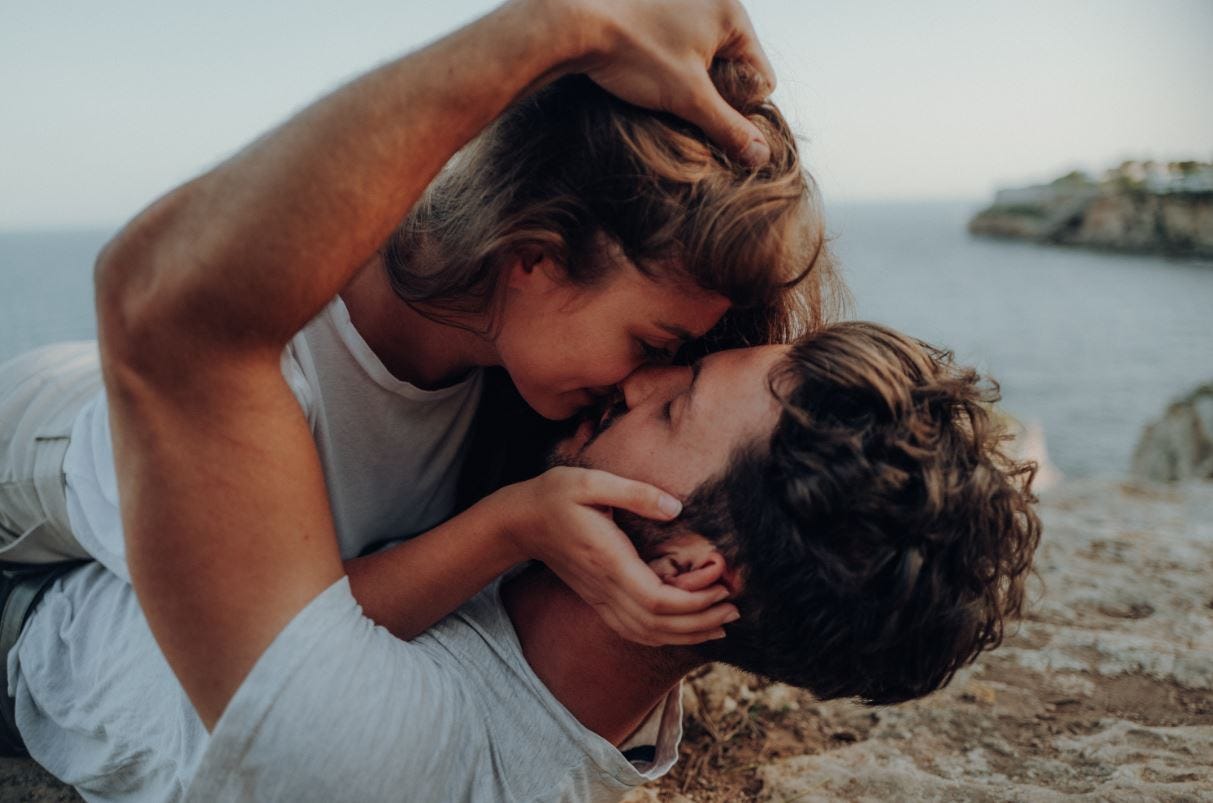 Couple kissing by ocean Couple kissing by ocean