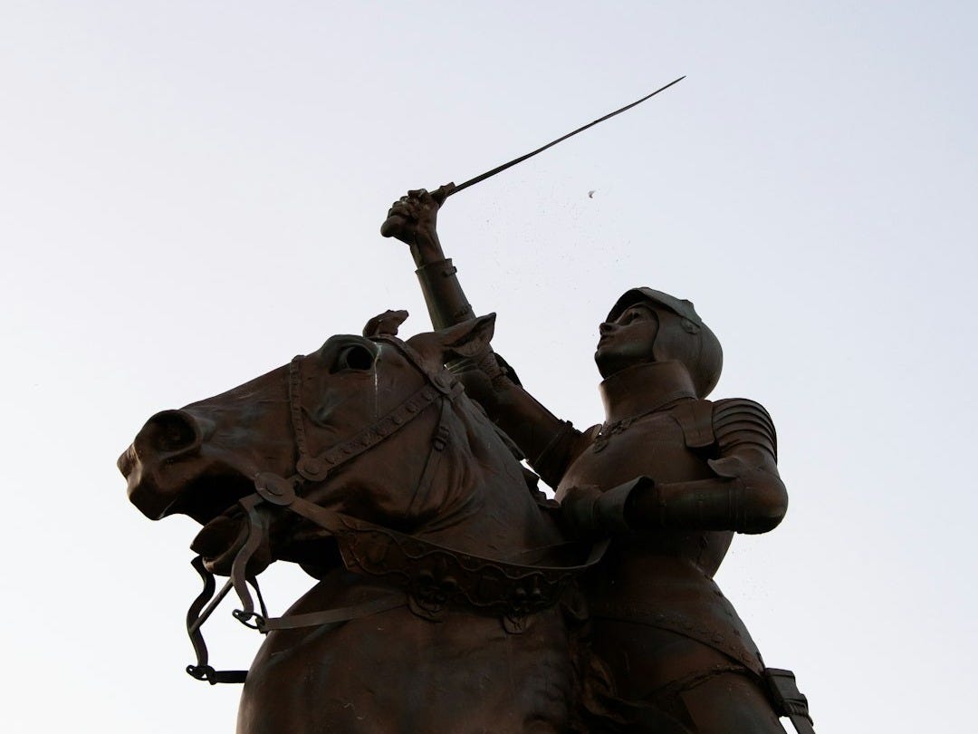 Statue depicts joan of arc on horseback.