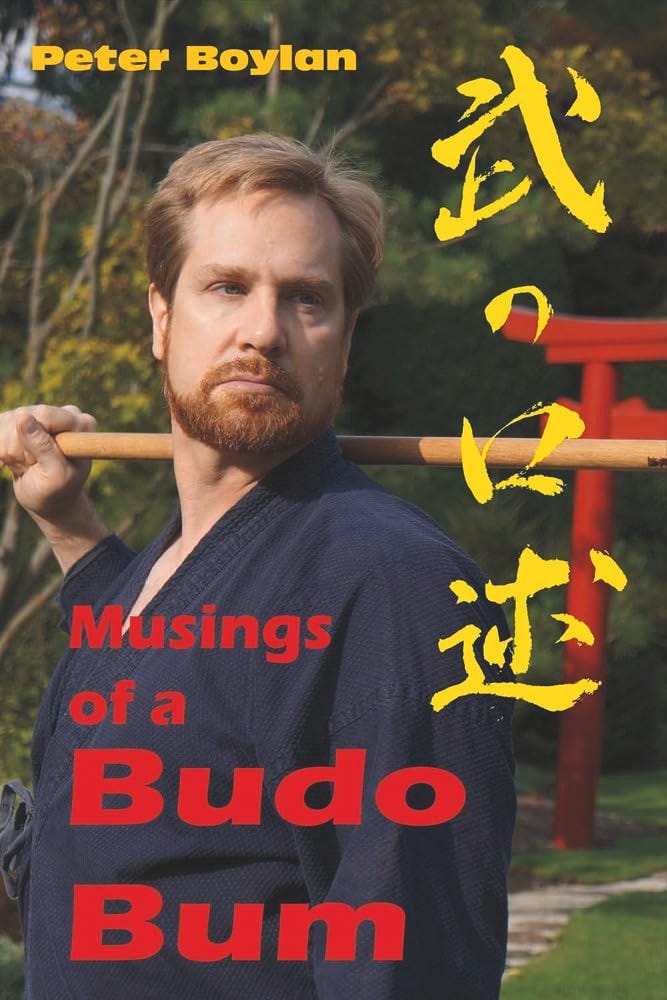 Photo of cover of book Musings Of A Budo Bum, showing Peter Boylan holding a jo.