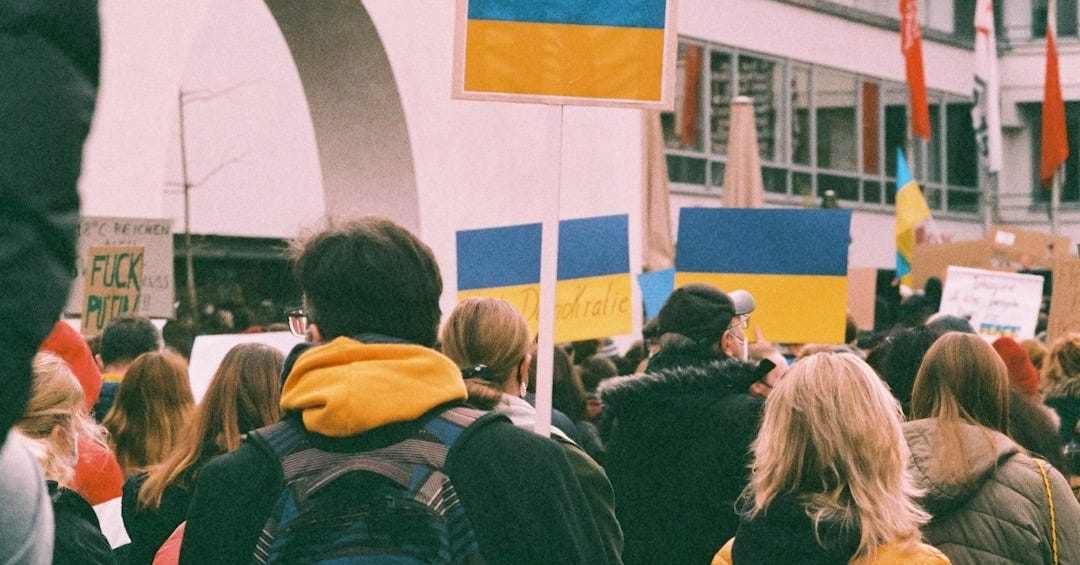 a crowd of people walking down a street