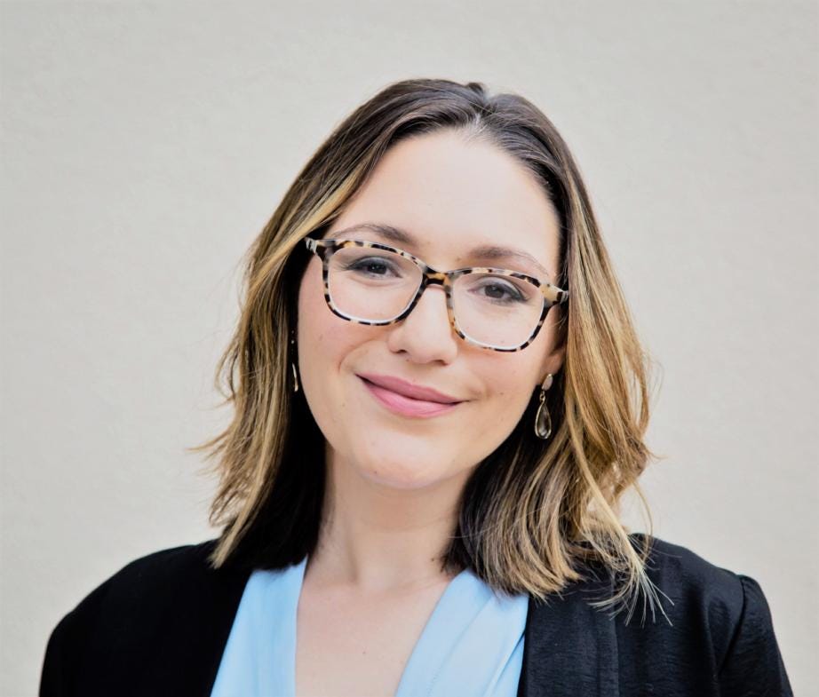 professional woman with glasses and suit coat