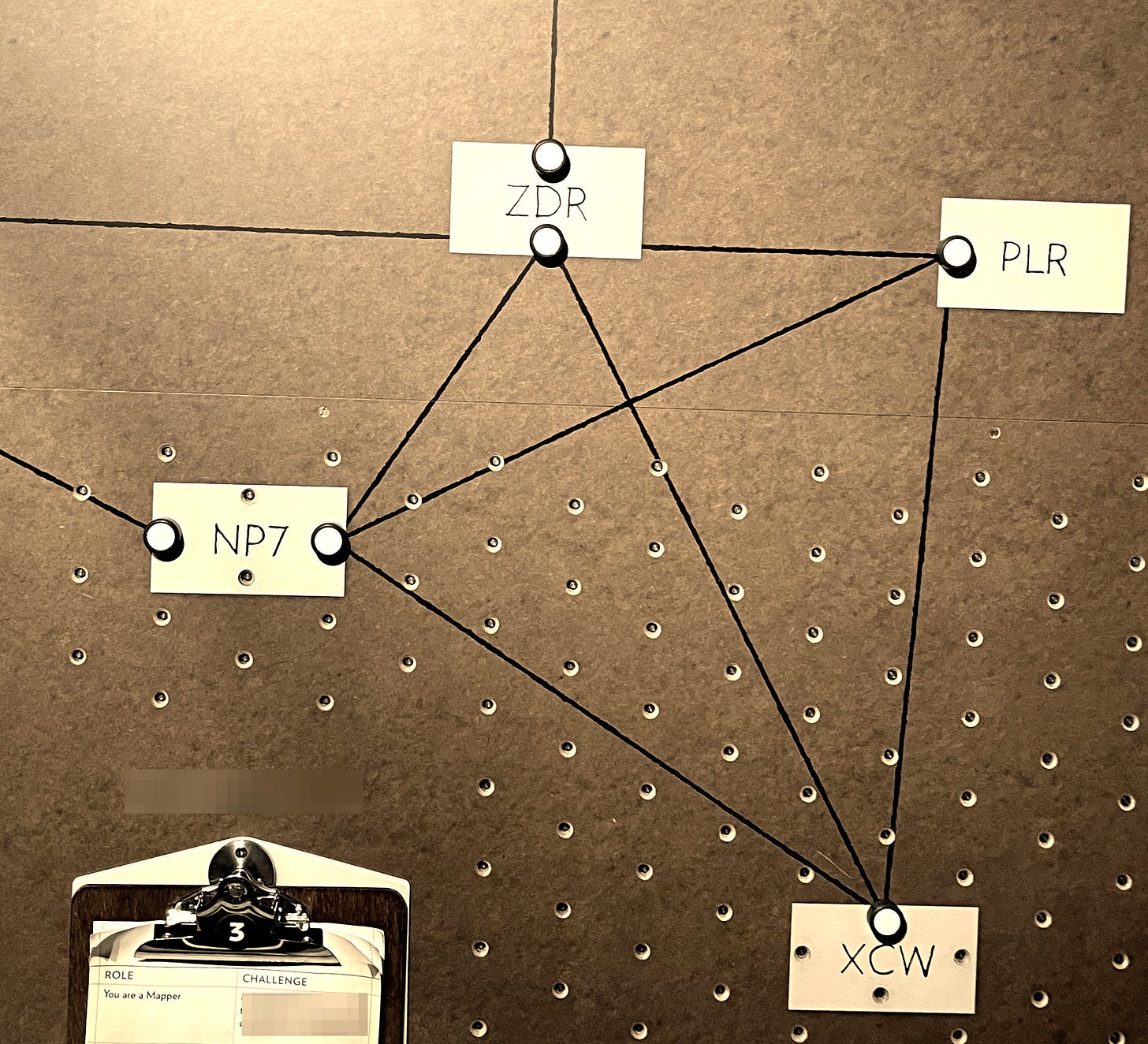 Pegboard with coded labels on notecards with connecting lines as depicted at Bletchley Park.