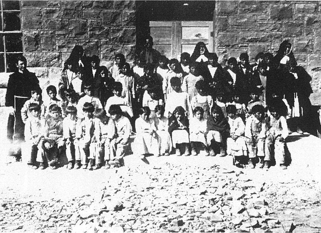 1923. Fr. Anthony Kroger (left) and the first enrollment of students.