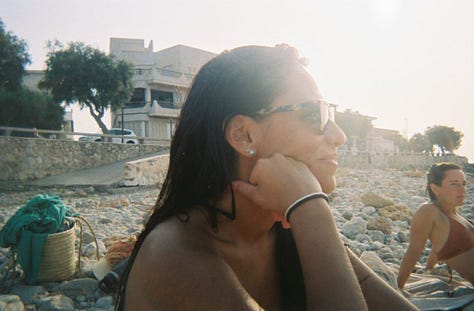 One row of three photos, left to right: Two women wading in the water along the edge of a swimming pool, with two women on shaded lounge chairs in the background, all smiling to camera; Profile of woman sitting on the beach wearing sunglasses, fist to chin, smirking, with a second woman leaning back on her palms on a beach towel on the sand, profiled and gazing out of frame; Four women taking a selfie, smiling wide, in a cityscape with parked cars, a white building, and a palm tree in the background.