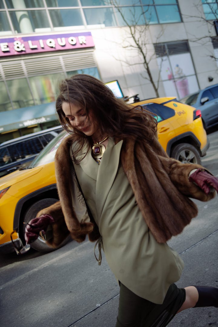 Street style images from NYFW showing Sarah Dewald in a brown fur jacket over a sage green dress with burgundy gloves, and Elsa Hosk in a sculptural white coat and matching hat.