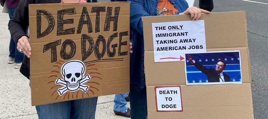 A group of people holding signs

AI-generated content may be incorrect.