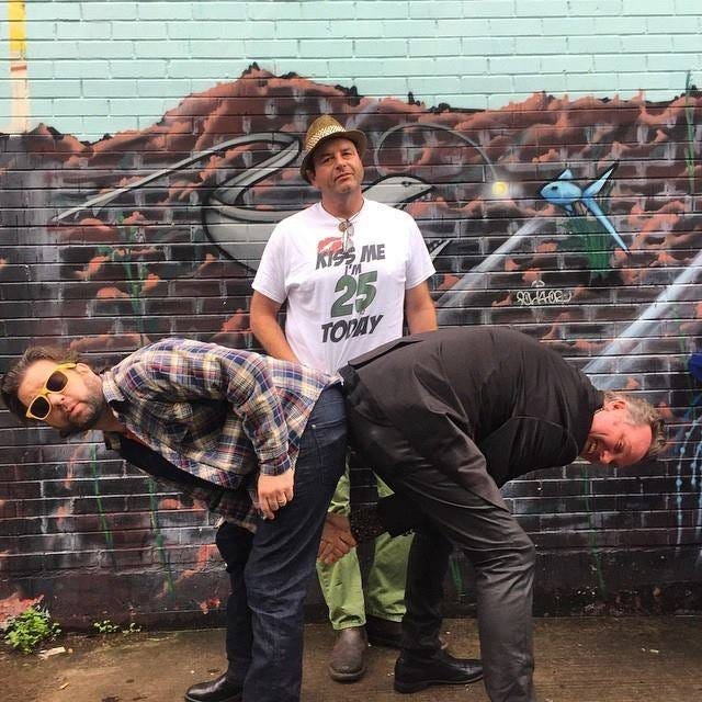 A group of men posing for a picture

AI-generated content may be incorrect.