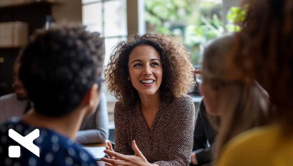 woman executive sitting at a table with a diverse group of people