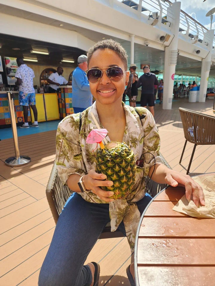 Photos of the Caribbean ocean, the sandy beaches, and water and sky! And a black chick taking pictures of everything and sitting drinking a pineapple drink.