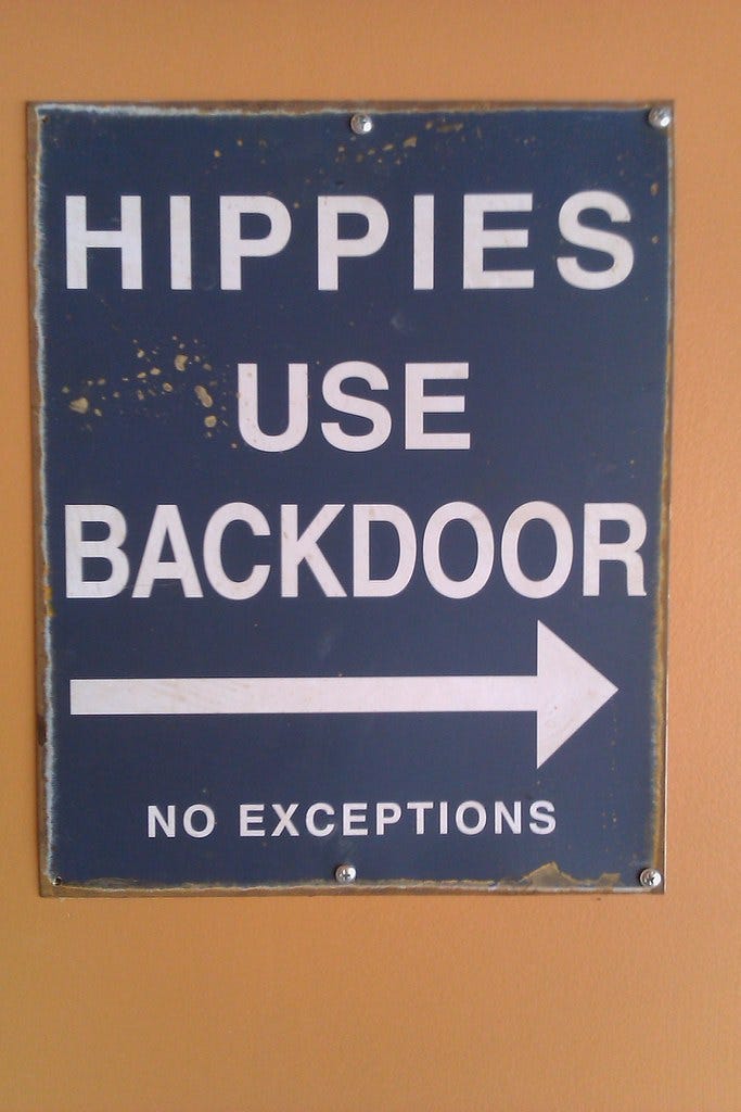 a sign reading "Hippies Use Backdoor: no exceptions" a sign reading "Hippies Use Backdoor: no exceptions"