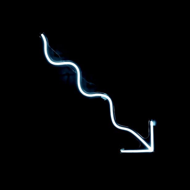 a blue neon sign on a black wall