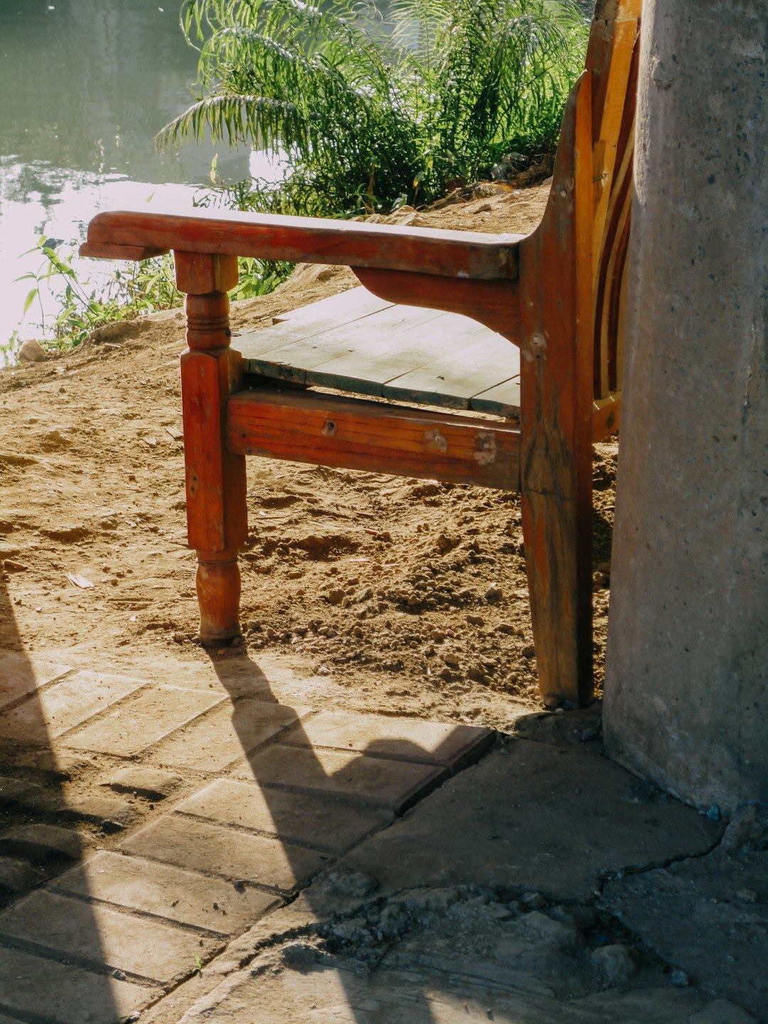 a wooden bench sitting next to a body of water