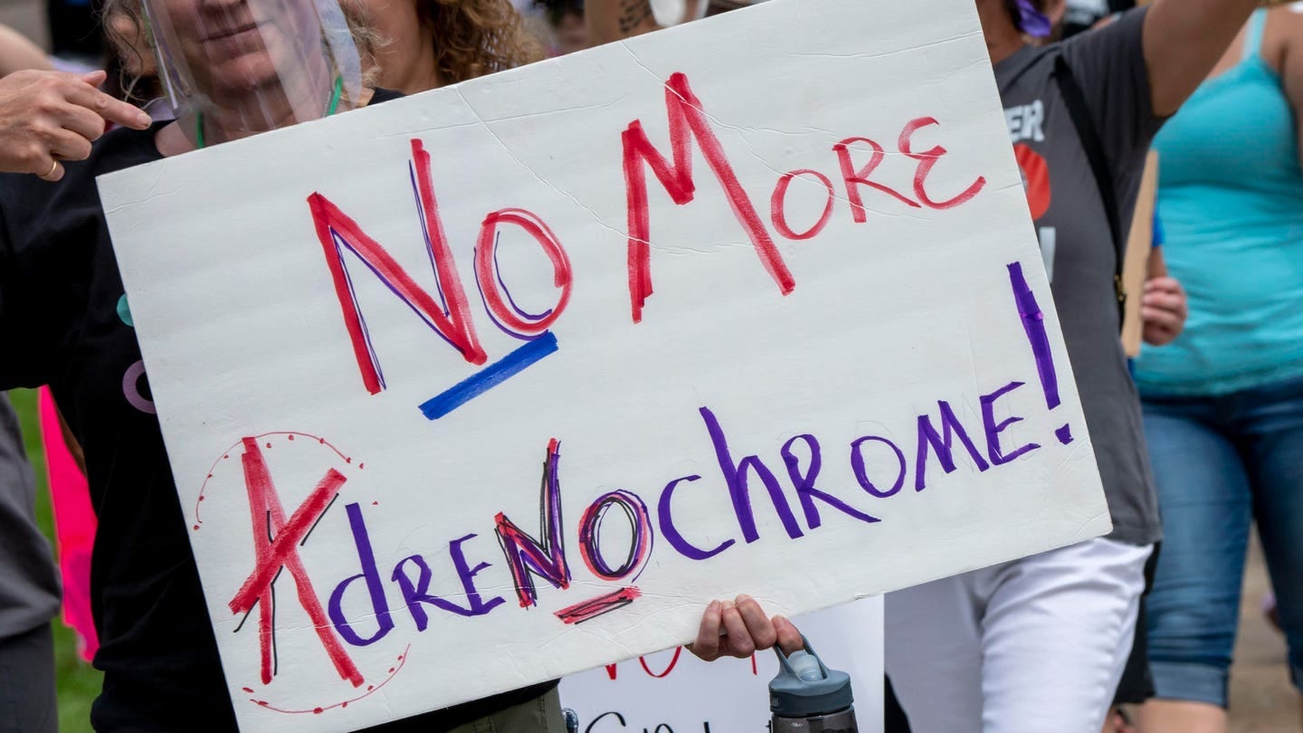 St. Paul, Minnesota, Save our children protest. Protesters marching while holding signs at a save our children rally. Protester with a no more adrenochrome sign.
