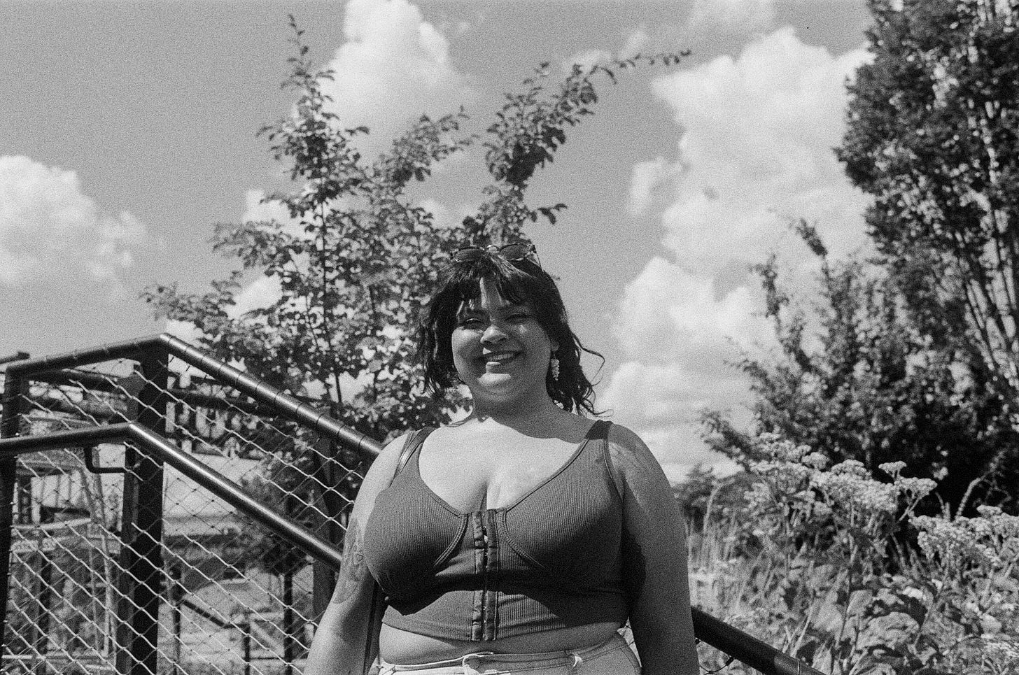 ena gangula black and white photo outdoors smiling in crop top