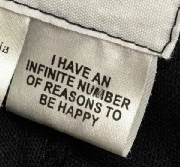 This may contain: a label on a black jacket that says i have an infinite number of reason to be happy