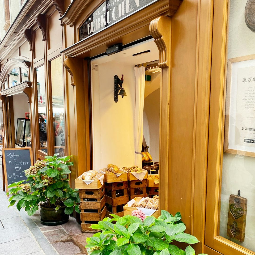 a store front with a bunch of plants in front of it