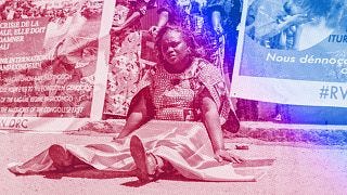A woman holds a Democratic Republic of Congo (DRC) flag during a protest against the conflict in eastern DRC, February 2023