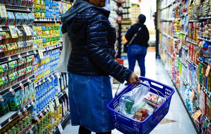 Shoppers in a grocery store aisle