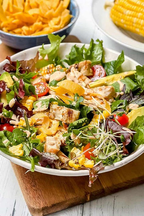Six dinner salad recipes including Asian coleslaw, Caesar salad with chicken, salmon salad, Southwest chicken salad and a quick taco salad.