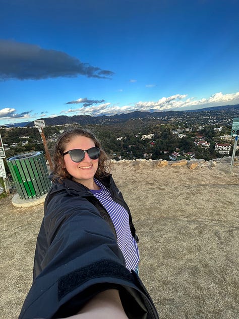 the map of the trails, views from the trails, including the locks on a fence line and the paved path down, and Hannah smiling with the Hollywood sign - pretty far behind her