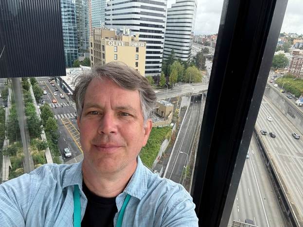 Jak Koke selfie – top floor of the Seattle Convention Center – Summit, looking down on Interstate 5 and some of the downtown buildings.