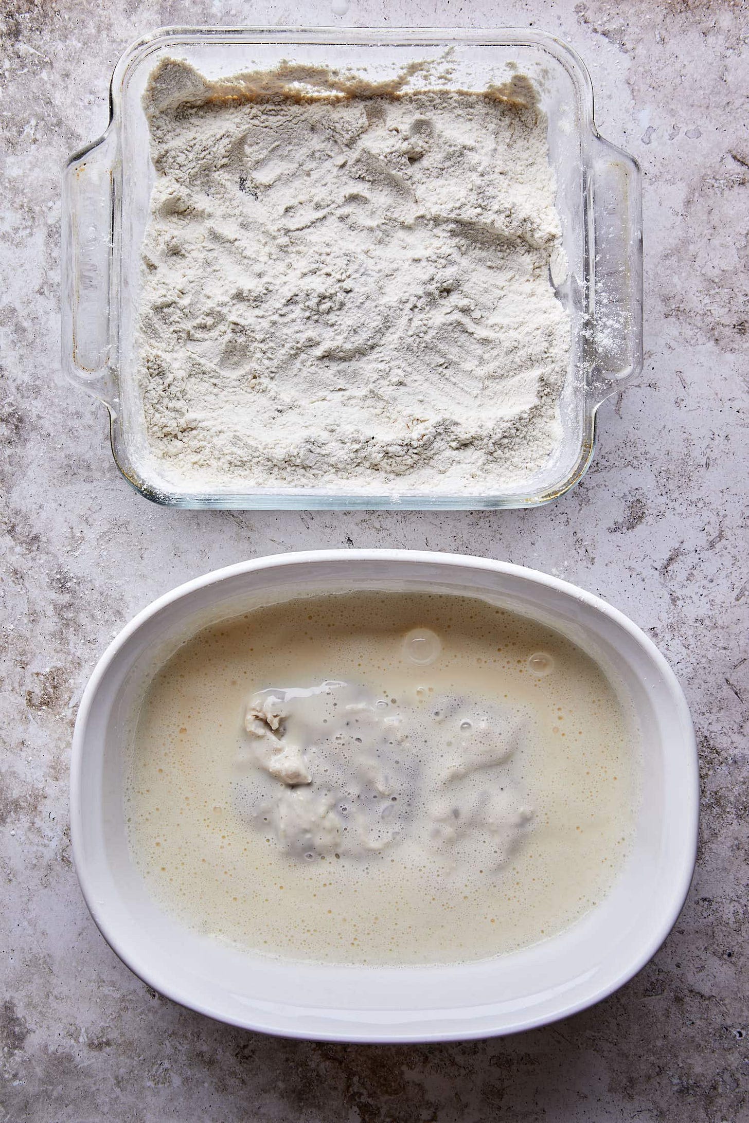 Chicken thighs soaking in a seasoned buttermilk brine to stay juicy for the best fried chicken sandwich recipe.
Chicken thighs soaking in a seasoned buttermilk brine to stay juicy for the best fried chicken sandwich recipe.