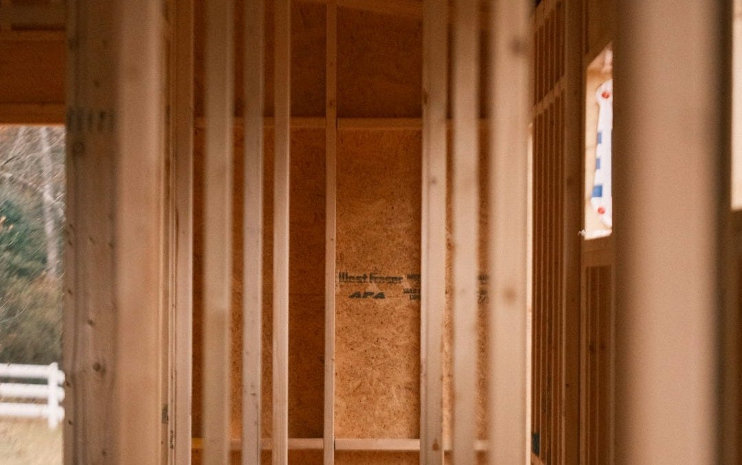 a room that is under construction with wooden framing