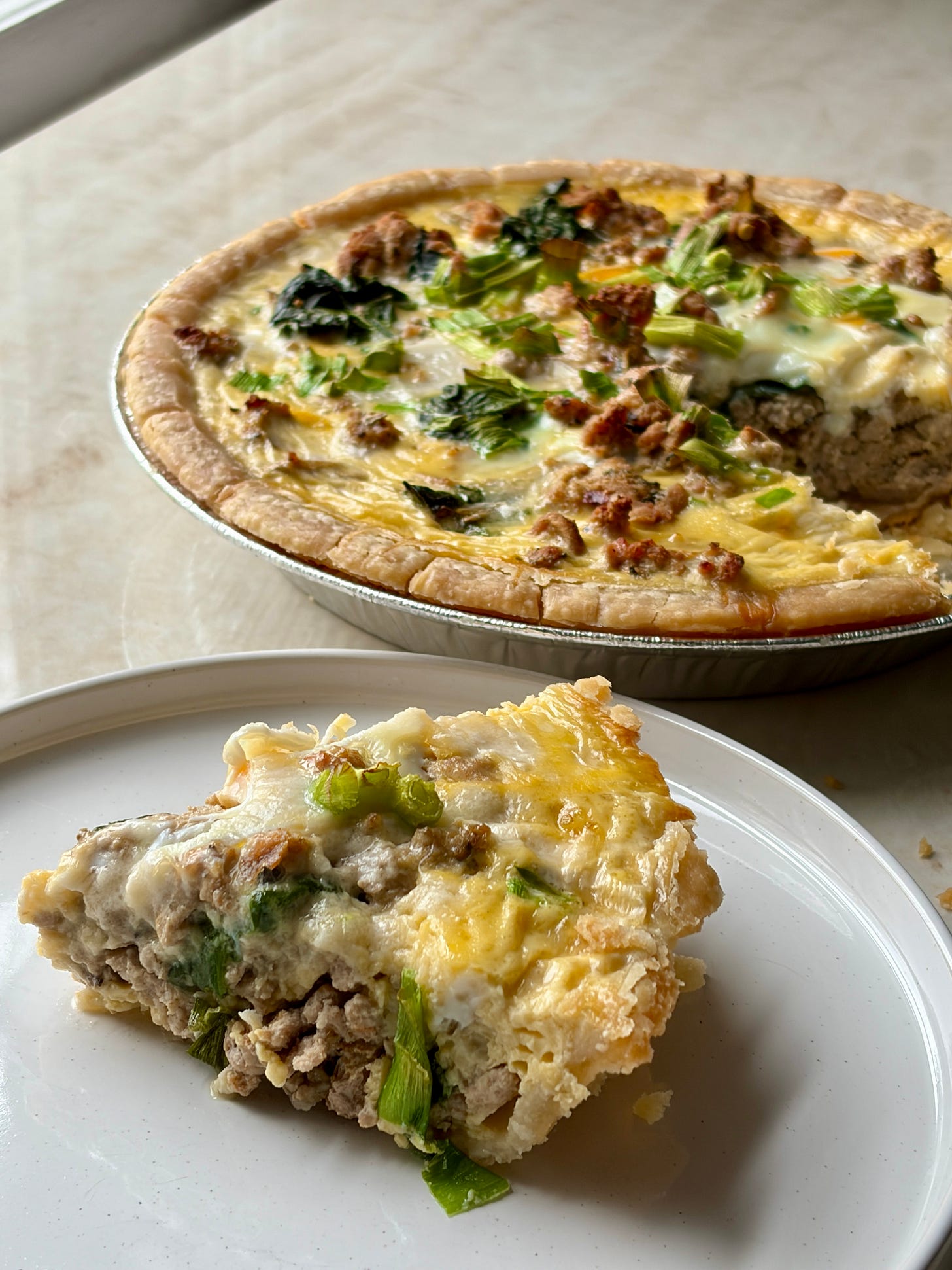 Gluten-free spinach turkey quiche, sliced on a plate Gluten-free spinach turkey quiche, sliced on a plate