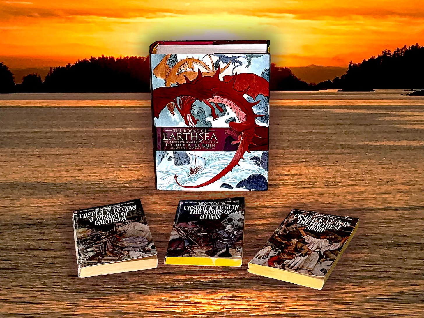 In the forefront my old paperbacks of the Earthsea Trilogy by Ursula K. Le Guin illustrated by Gail Garraty and Ruth Robbins. In the background a recent gift from Tom, The Books Of EARTHSEA  The Complete Illustrated Edition by Ursula K. Le Guin illustrated by Charles Vess. I placed the books in front of a favorite view of sunset as seen in Sitka, Alaska.