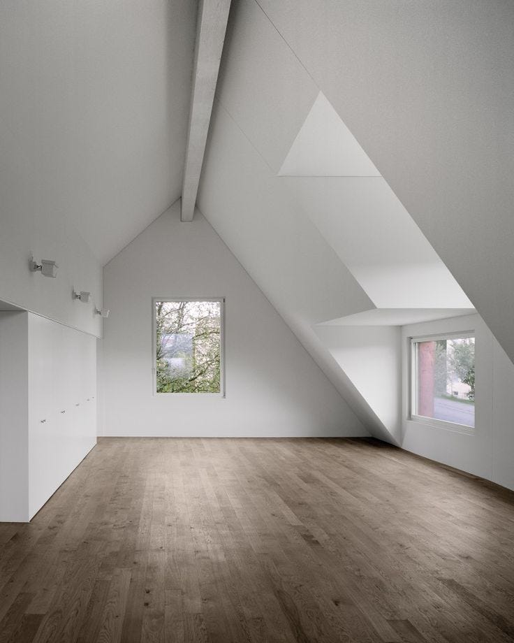 This may contain: an empty room with white walls and wooden floors is seen in this image from the inside