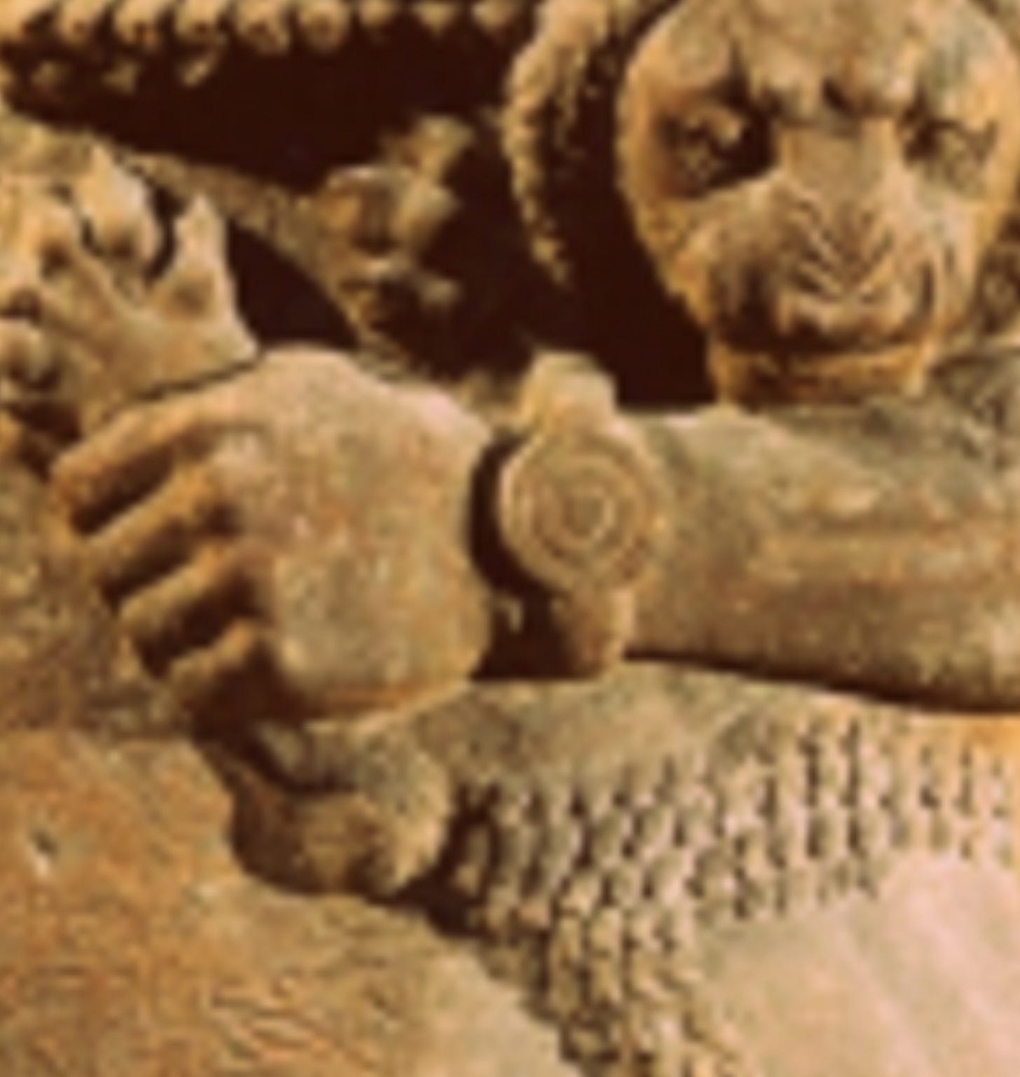 A close up of the statue's wrist, on which he is wearing a bangle that looks very much like a watch. Once again, Visually Impaired Squadron, it falls a bit flat if you have to spell it out. Sorry.