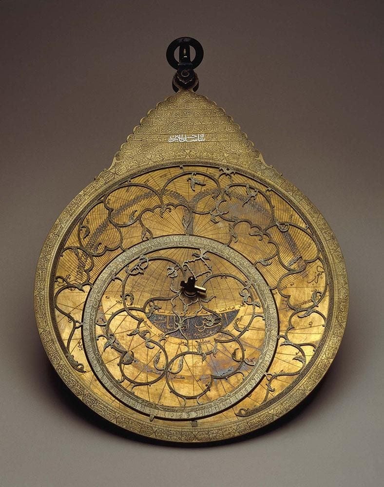 Astrolabe, made of brass and marked with pointers to important stars and cities throughout the Islamic world.