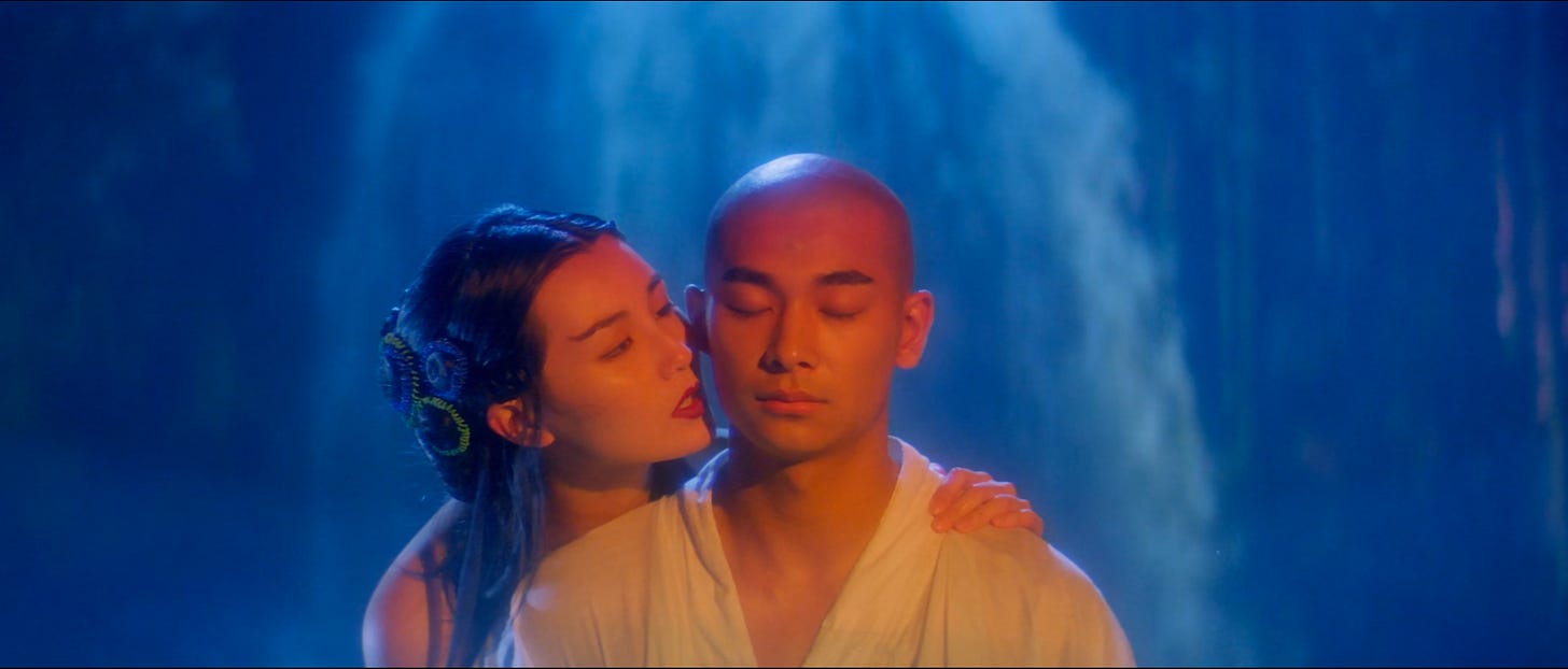 Still from Green Snake (1993) featuring a man and a woman in front of a waterfall