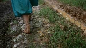 Barefoot Girl Walking Through Muddy ...