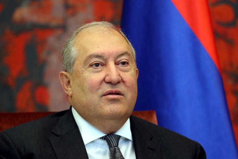 Armenian President Armen Sarkissian looks on