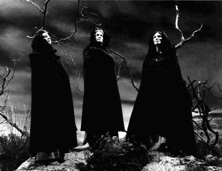 This may contain: three witches standing in front of a dark sky