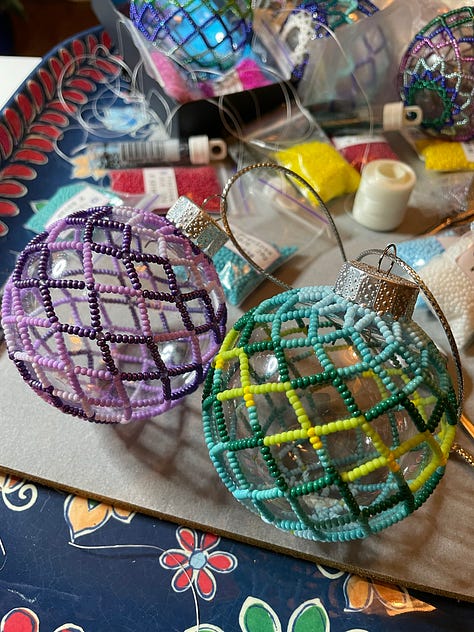 Beaded holiday ornaments, pinback buttons and knitted hats