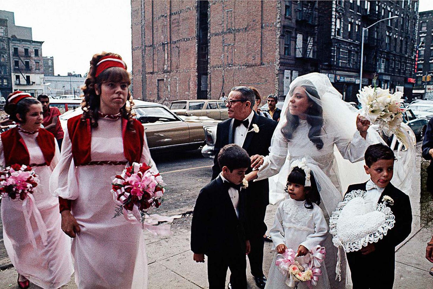 Bustling pedestrians navigate a litter-strewn sidewalk in a forgotten part of 1970s NYC. Bustling pedestrians navigate a litter-strewn sidewalk in a forgotten part of 1970s NYC.
