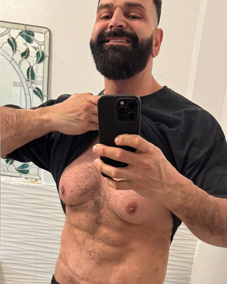 Selfie of a man lifting his shirt to show his chest. Selfie of a man lifting his shirt to show his chest.
