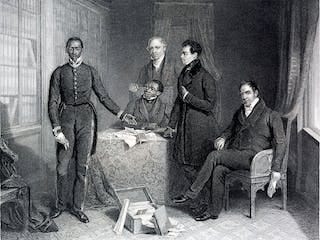 A vintage illustration in black and white of an African man in formal western attire standing next to a table where three other men stand and sit in a lavish drawing room. A vintage illustration in black and white of an African man in formal western attire standing next to a table where three other men stand and sit in a lavish drawing room.