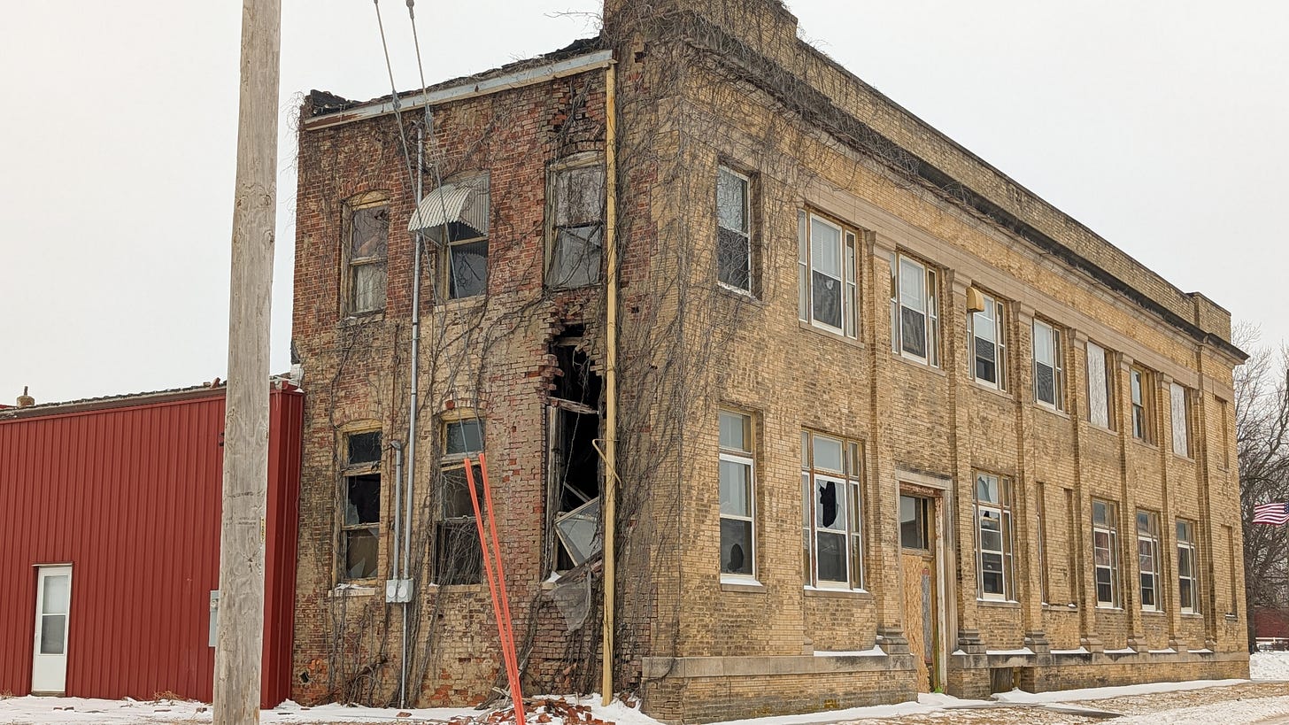 a two-story brick building, in complete disrepair