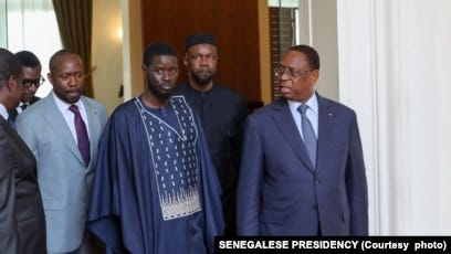 This handout picture distributed by the Senegalese Presidency on March 28, 2024 shows opposition leader Ousmane Sonko (2nd R), outgoing Senegalese President Macky Sall (R) and Senegal's president-elect Bassirou Diomaye Faye (3rd R) walking at the Presidential palace in Dakar. This handout picture distributed by the Senegalese Presidency on March 28, 2024 shows opposition leader Ousmane Sonko (2nd R), outgoing Senegalese President Macky Sall (R) and Senegal's president-elect Bassirou Diomaye Faye (3rd R) walking at the Presidential palace in Dakar.