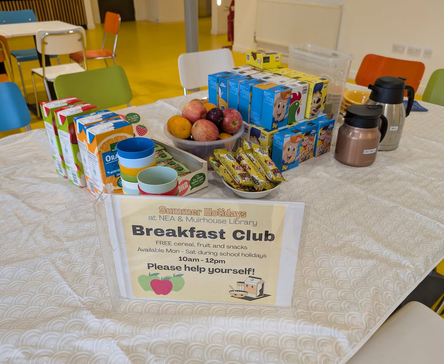 May be an image of table, children's toy and text that says "ORA ききの代 BAE Sumtner Holidays at NEA Muirhouse Library Breakfast Club FREE cernal, fruit nd snarks Available Mon Get. during school schaolholidays olidays 10am 12pm Please help yourself!"