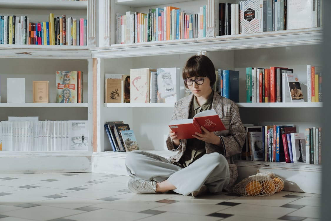 Free Woman in Gray Long Sleeve Shirt Reading Book Stock Photo