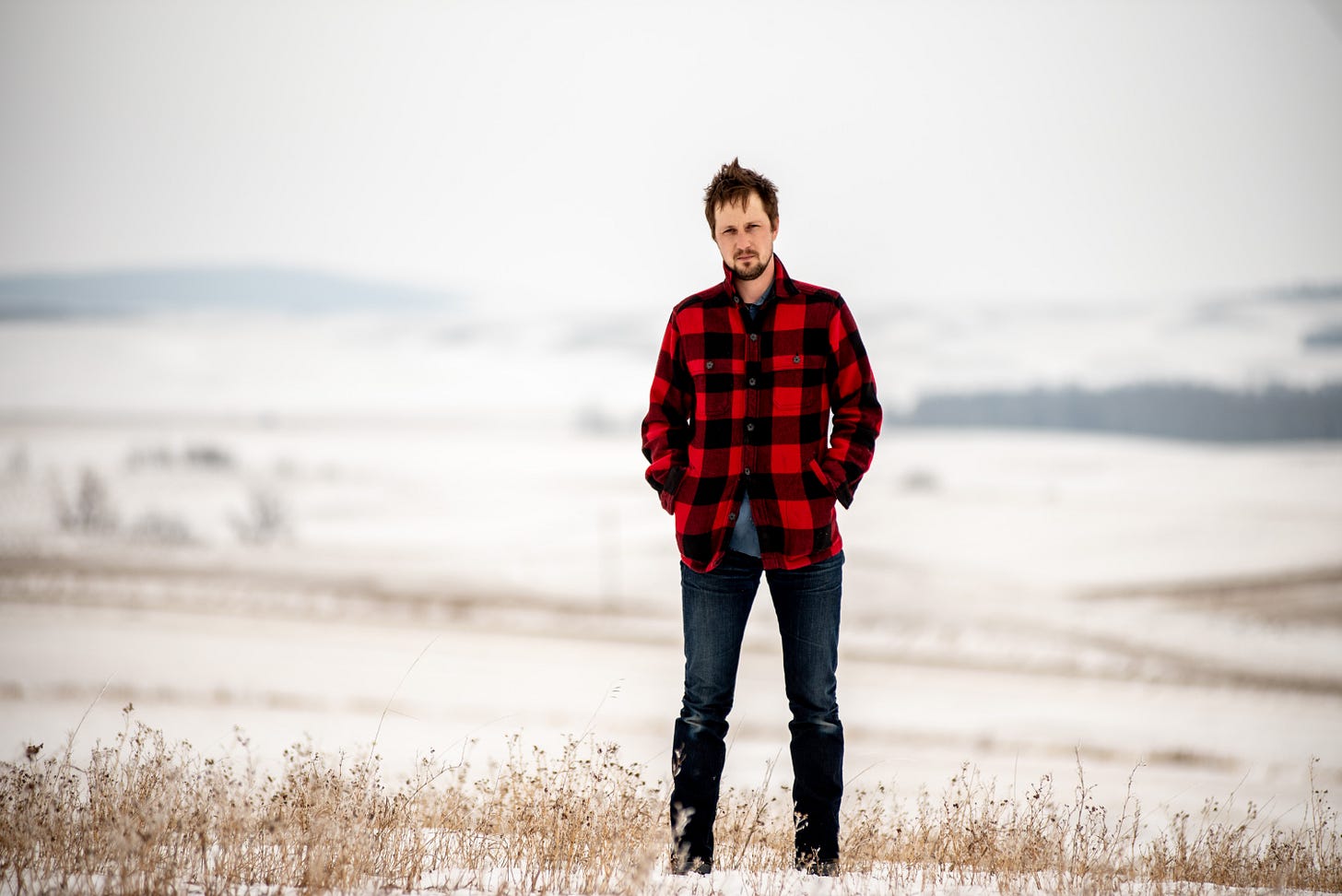 Artist Del Barber standing on the Canadian prairie.