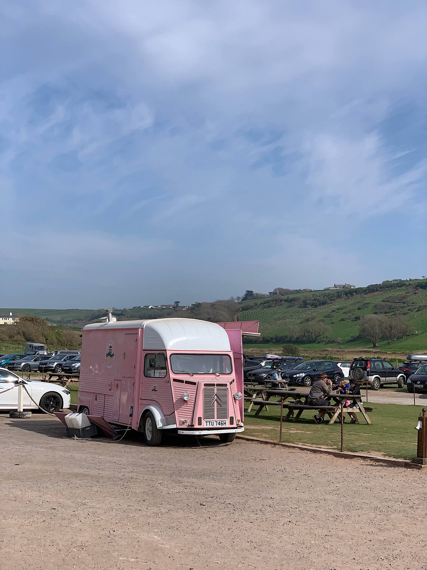 Vintage, pink Citroën ice cream van on Bantham Beach, Devon on a blue sky day