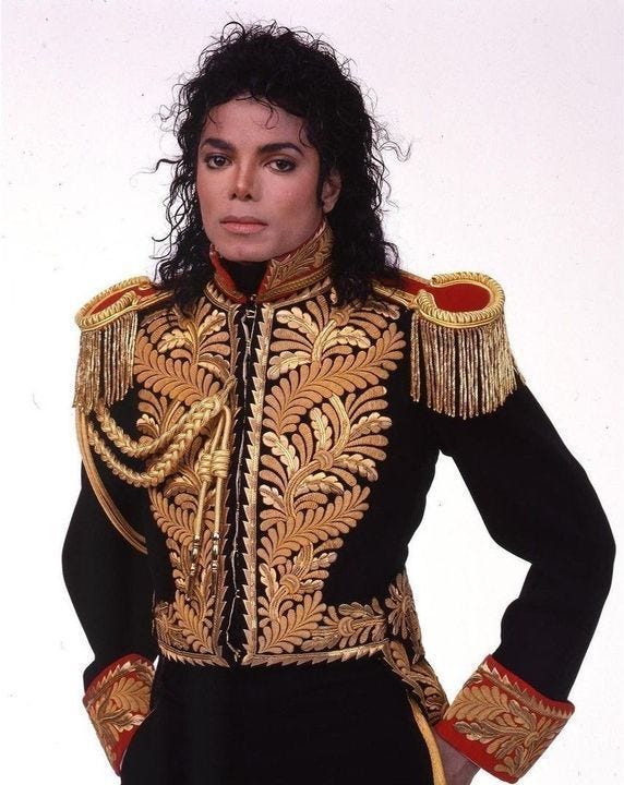 michael jackson as michael jackson in the rocky show, wearing an elaborate gold and black outfit
