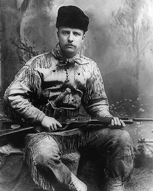 Theodore Roosevelt as the Badlands hunter. Theodore Roosevelt is in a hunting suit, and has a carved Tiffany hunting knife and rifle. Photographed by George Grantham Baine in 1885 in New York City. (Public Domain) Theodore Roosevelt as the Badlands hunter. Theodore Roosevelt is in a hunting suit, and has a carved Tiffany hunting knife and rifle. Photographed by George Grantham Baine in 1885 in New York City. (Public Domain)