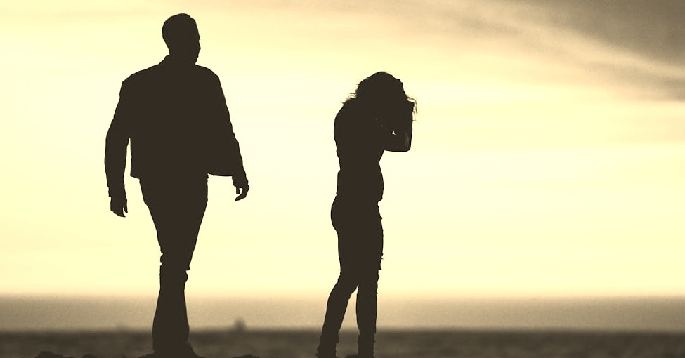 silhouette of man and woman under yellow sky