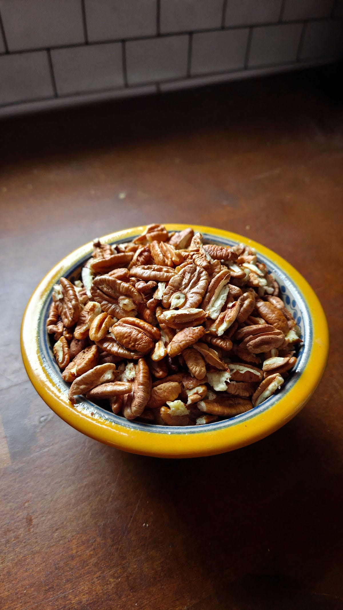 A bowl of cracked, foraged pecans. 